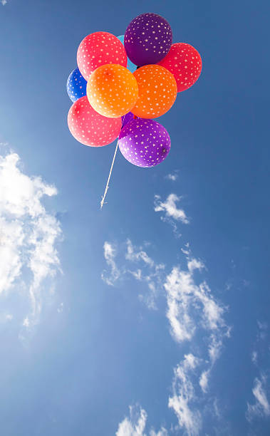 istock Colorful balloons flying on the blue sky 492005688