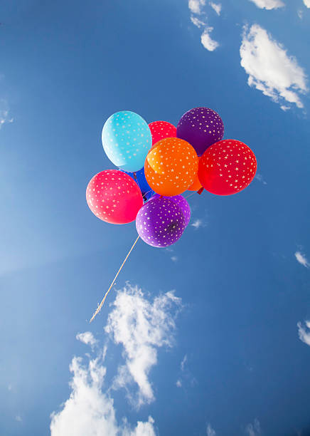 istock Colorful balloons flying on the blue sky 492005698