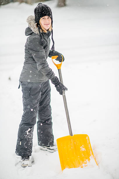 istock Woman Shoveling Snow Off Her Driveway 492006308
