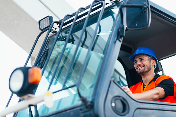 Construction machine operator Smiling construction machine operator at work stacker stock pictures, royalty-free photos & images