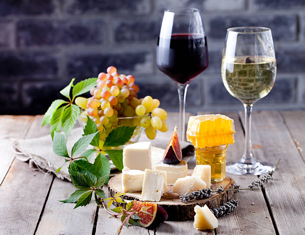 istock Cheese plate with honey, grape, wine in glasses 492009318