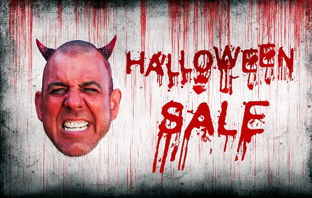 Photo of Halloween Sale sprayed on wall next to devils head