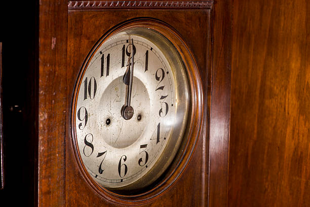 Closeup of an antique pendulum clock stock photo