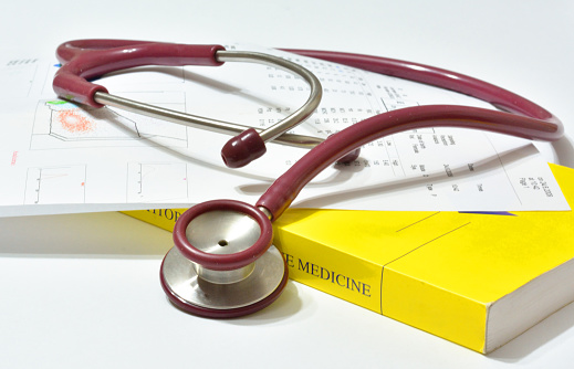 Stethoscope and book with medical lab test results