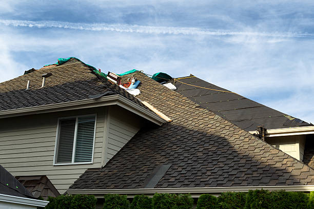 Home roof being replaced with new composite roofing materials stock photo