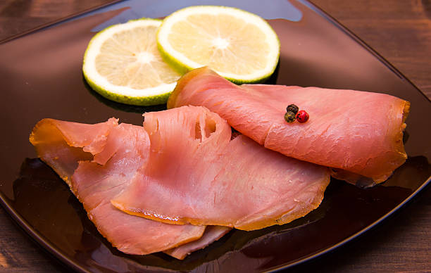 istock Smoked tuna on black plate on wooden close 492014644
