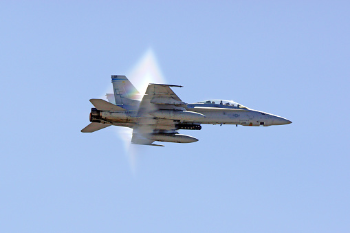 Miramar, California,USA- October 3, 2015. F-18 Hornet jet fighter breaking the sound barrier at 2015 Miramar Air Show in San Diego, California. The 2015 Miramar Air Show features 3 days of military aircraft and the US Navy Blue Angels demonstration team performing for the general public.