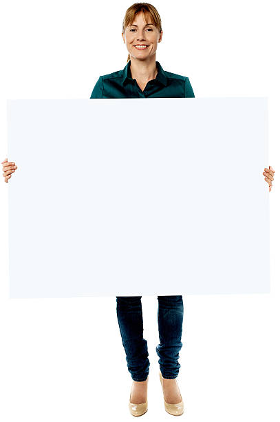 istock Attractive woman holding blank ad board 492021623