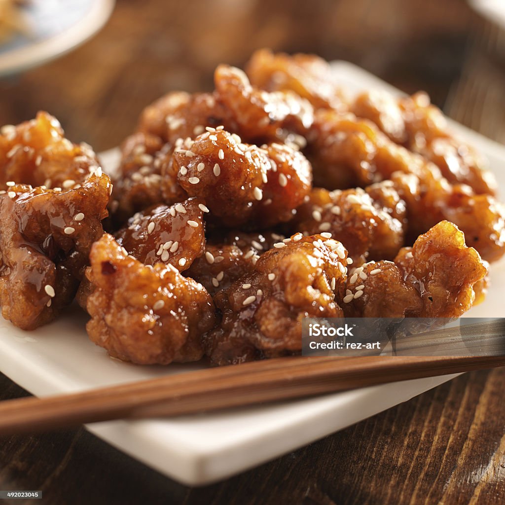 chinese sesame chicken with chopsticks chinese sesame chicken with chopsticks, shot with selective focus. Asia Stock Photo