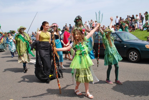 Hastings, England - May 5, 2014: Costumed people take part in a parade on the West Hill during the annual Jack In The Green festival. The event is held on the May Day public holiday in Britain.