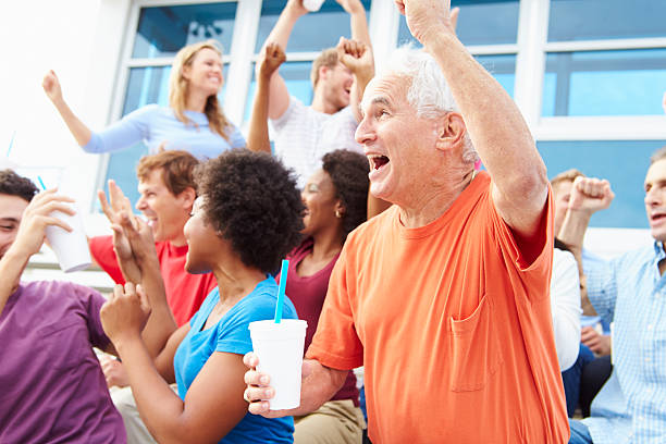 Spectators Cheering At Outdoor Sports Event Spectators Cheering At Outdoor Sports Event Celebrating sports event stock pictures, royalty-free photos & images