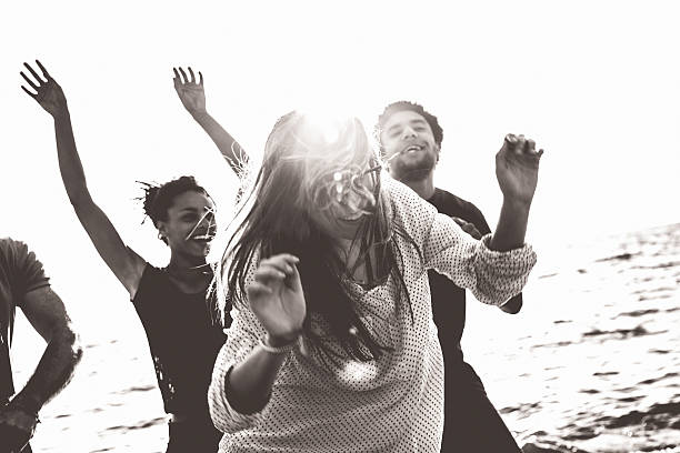 Group of multi-ethnic friends dancing on the beach