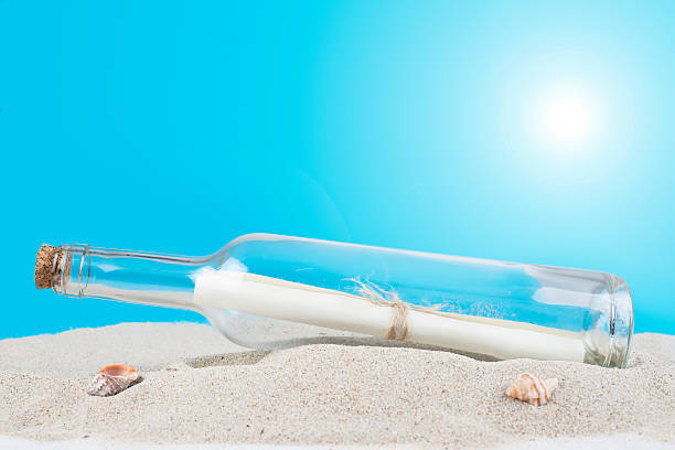 istock Message in a bottle on the sand of th beach 492026579