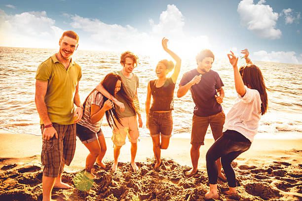 istock Multi-ethnic group of friends dancing on the beach 492028803