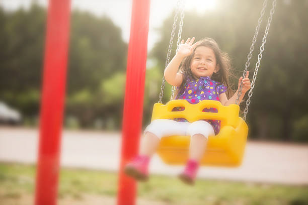 istock Girl swinging with a big smile 492028845
