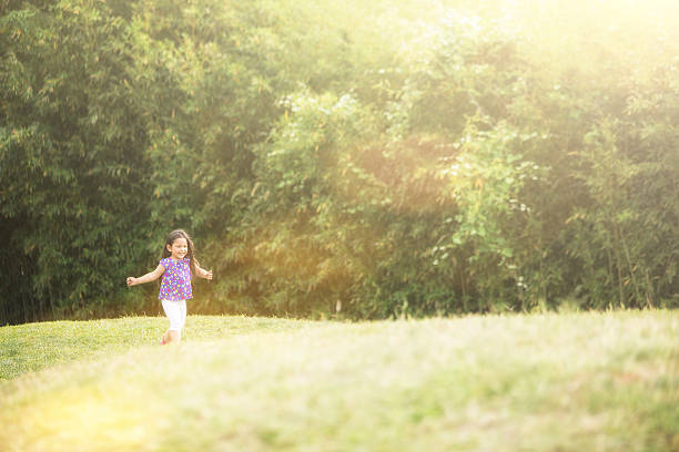 istock Running girl on green field 492028865