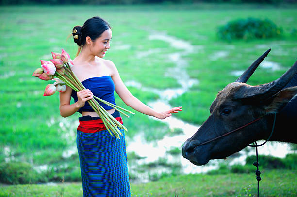 istock thai ancient young women with buffalo on rural 492030518