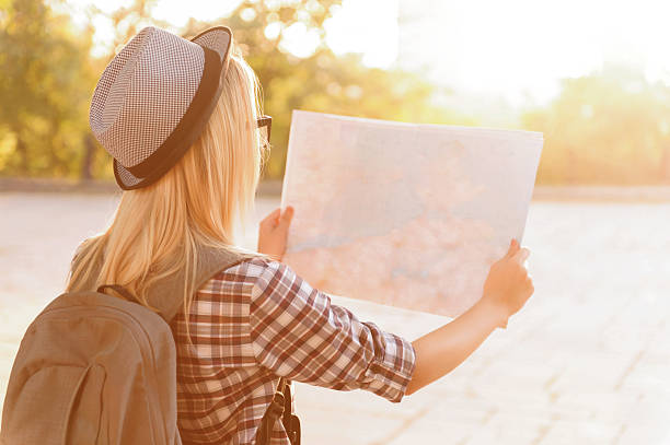 istock Cheerful girl holding map 492031282