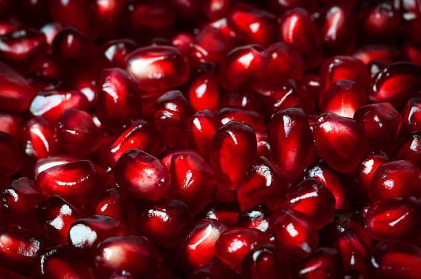 istock Delicious red ripe juicy pomegranate seed background texture macro closeup 492031700