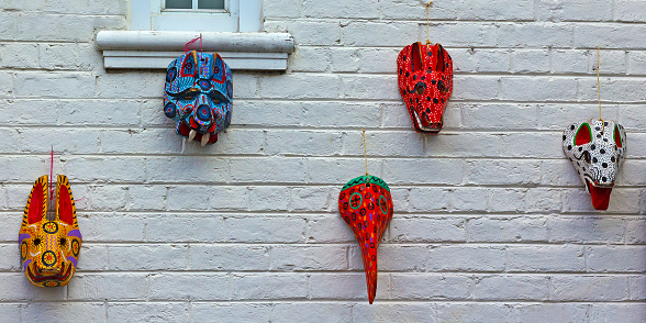 Building exterior wall with colorful animal masks.