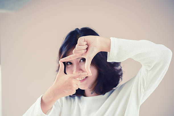 istock asia beutiful girl make hand symbol frame 492035524