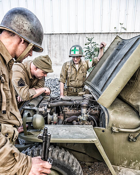 istock WWII US Army Soldiers Checking Jeep Military Vehicle Stalled Engine 492035694
