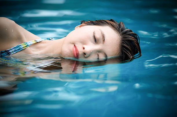 istock Young woman in the swimming pool 492037232