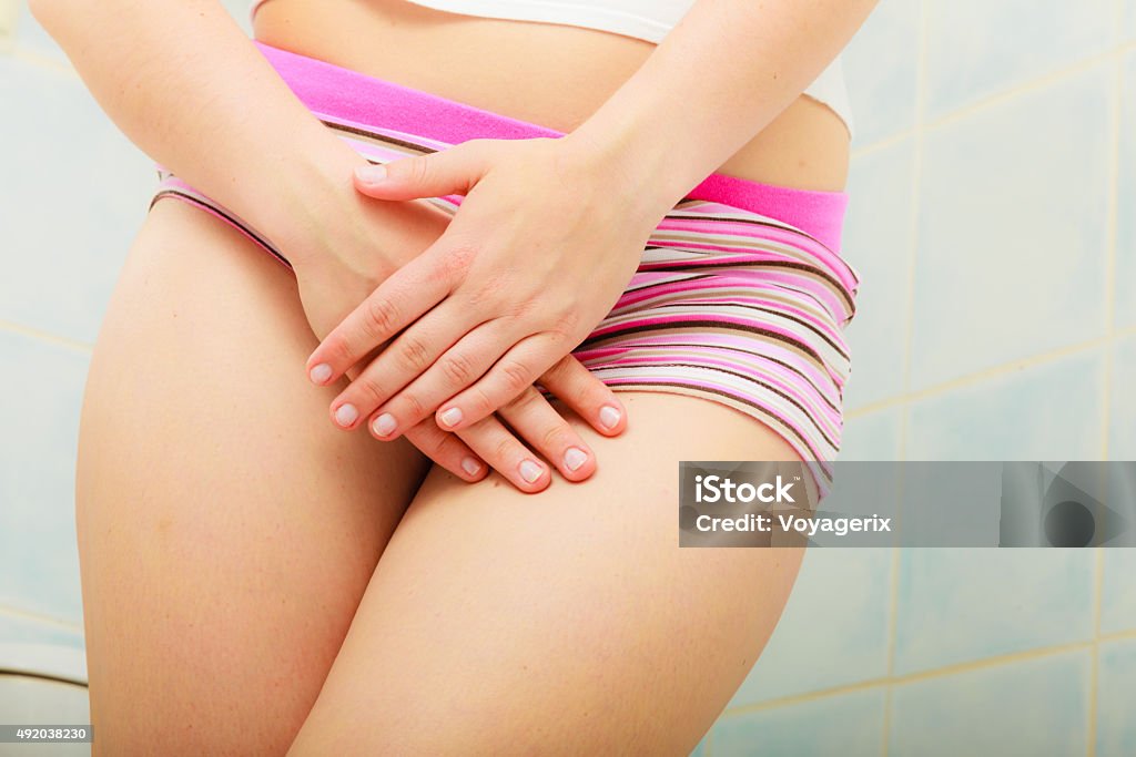 woman holds hands over her genital Medical or gynecological problems. Close up woman in panties with hands holding her crotch Vagina Stock Photo