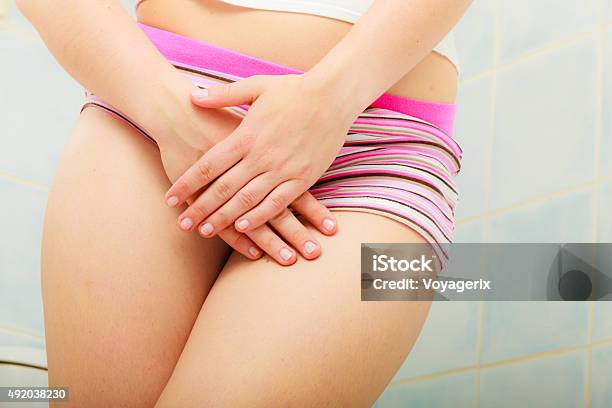 Woman Holds Hands Over Her Genital Stock Photo - Download Image Now - Vagina, Women, Pain