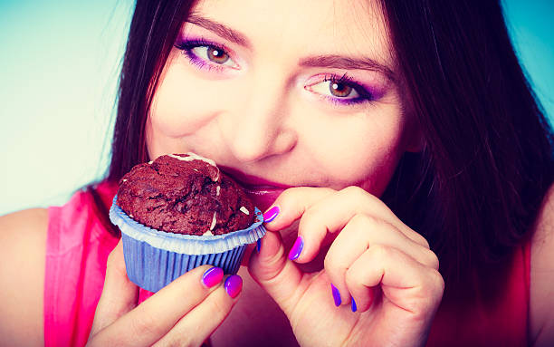 istock Smiling woman holds chocolate cake in hand 492038314