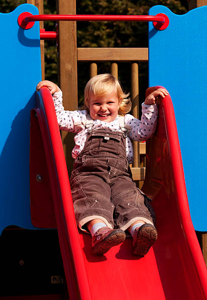 istock Happy little girl on slide 492040762