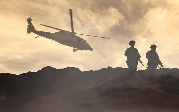 istock Soldiers wait for a Helicopter in Dust Storm 492040802