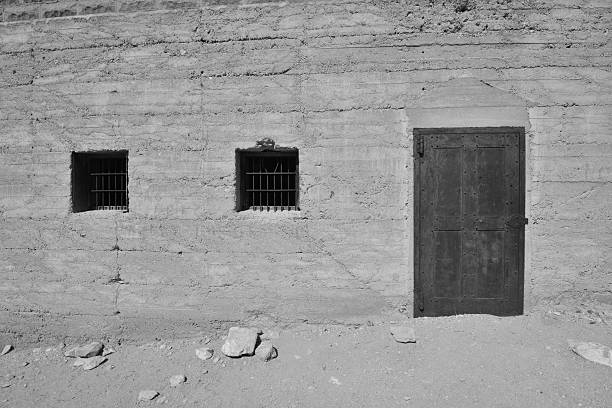 Rhyolite is a ghost town in Nye County, in the U.S. state of Nevada. It is in the Bullfrog Hills, about 120 miles (190 km) northwest of Las Vegas, near the eastern edge of Death Valley. The town began in early 1905 as one of several mining camps that sprang up after a prospecting discovery in the surrounding hills. During an ensuing gold rush, thousands of gold-seekers, developers, miners and service providers flocked to the Bullfrog Mining District. Many settled in Rhyolite, which lay in a sheltered desert basin near the region's biggest producer, the Montgomery Shoshone Mine.