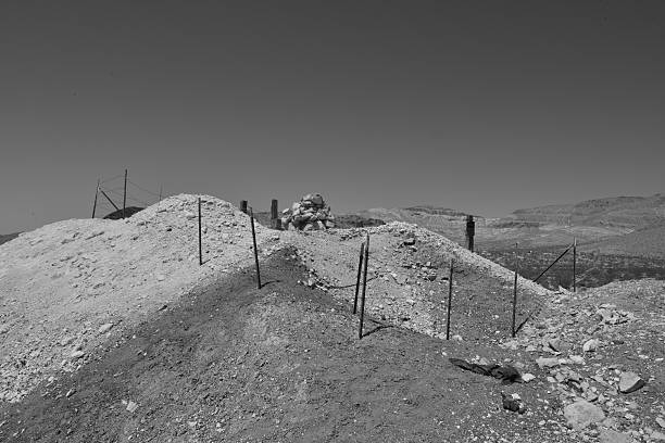 Rhyolite is a ghost town in Nye County, in the U.S. state of Nevada. It is in the Bullfrog Hills, about 120 miles (190 km) northwest of Las Vegas, near the eastern edge of Death Valley. The town began in early 1905 as one of several mining camps that sprang up after a prospecting discovery in the surrounding hills. During an ensuing gold rush, thousands of gold-seekers, developers, miners and service providers flocked to the Bullfrog Mining District. Many settled in Rhyolite, which lay in a sheltered desert basin near the region's biggest producer, the Montgomery Shoshone Mine.