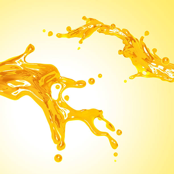 istock couple of liquid yellow orange juice. Dynamic liquid splash 492043136