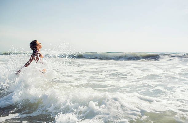 Girl jumping in the waves