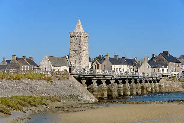 Church of Notre-Dame and old bridge at Port-Bail or Porbail, a commune in the peninsula of Cotentin in the Manche department in Lower Normandy in north-western France