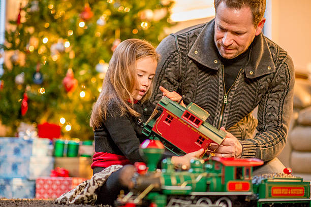istock Little Girl Looking at Her New Train Set 492044768