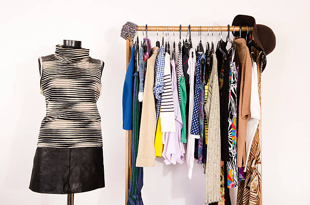 istock Dressing closet with colorful clothes arranged on hangers. 492045224