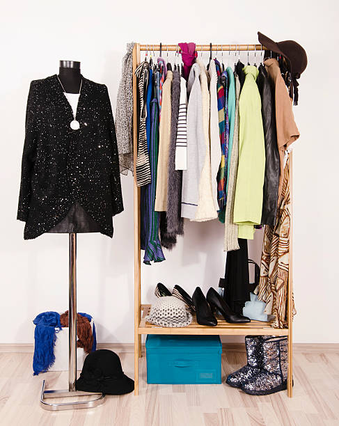 istock Wardrobe with winter clothes arranged on hangers. 492045258