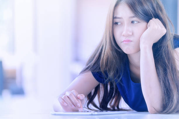 istock asia beautiful girl with tablet lying on floor 492045650