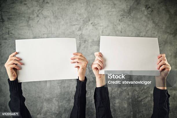 Two Women Holding Blank Paper Posters Stock Photo - Download Image Now - Adult, Banner - Sign, Blank