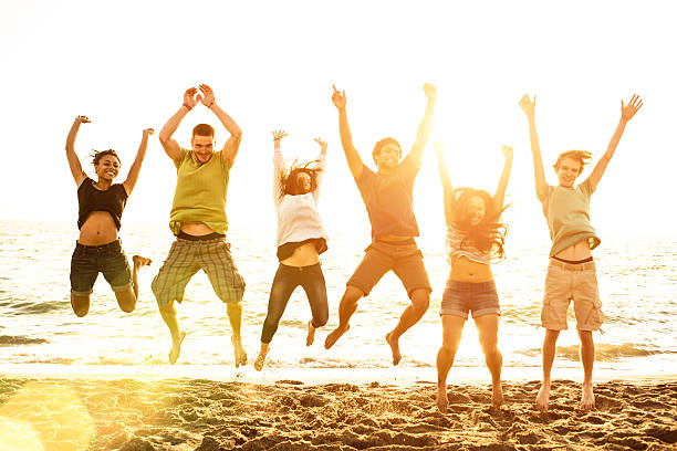 istock group of friends jumping on the beach 492056863