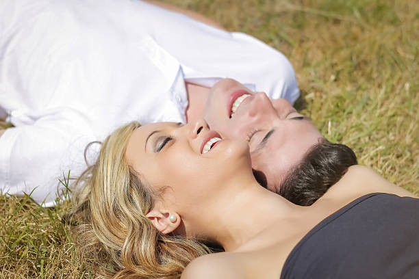 istock Love couple laughing lying on grass in summer day 492058829