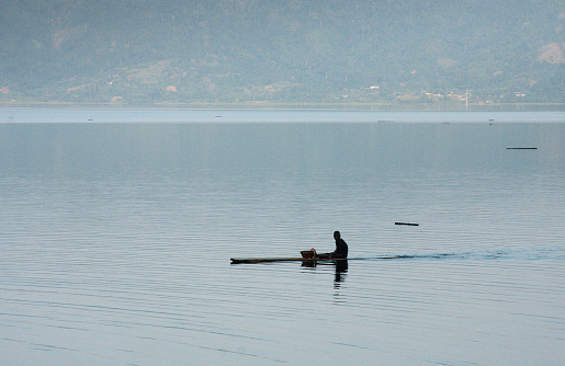 Kumasi, Ghana - August 5, 2010: Man at the traditional fishing at the lake Bosumtwi, located near big city Kumasi in Ghana. 