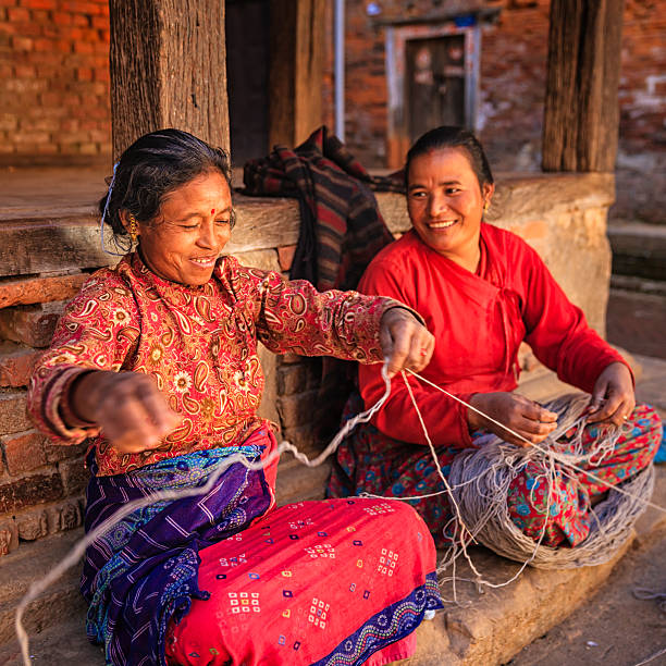 istock Two Nepali women  spinning a wool in Bhaktapur, Nepal 492060613