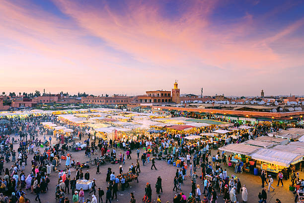Evening Djemaa El Fna Square with Koutoubia Mosque, Marrakech, Morocco Famous Djemaa El Fna Square in early evening light, Marrakech, Morocco with the Koutoubia Mosque, Northern Africa.Nikon D3x marrakesh photos stock pictures, royalty-free photos & images