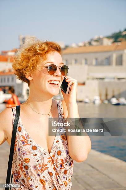 Young Cheerful Woman On The Phone Stock Photo - Download Image Now - 20-29 Years, 2015, Adult