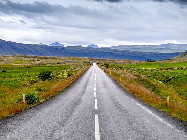 istock empty rural country road in volcanic landscape on Iceland 492071076