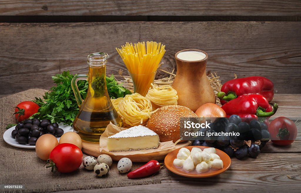 concept of a balanced diet Set of different foods on the old wooden background, vegetables, pasta, fruit, eggs, dairy products, the concept of a balanced diet, the ingredients for Italian food 2015 Stock Photo